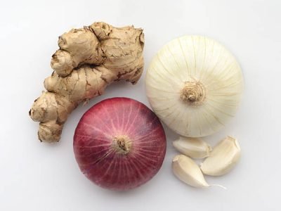 High resolution close up of ginger,garlic cloves,white onion and red onion shot in studio on white background.